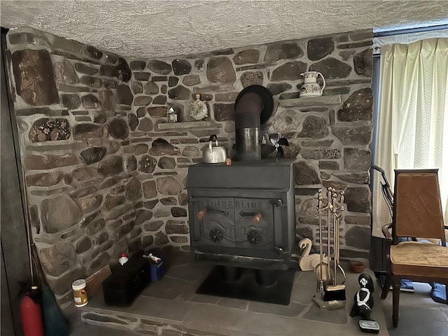 room details with a wood stove and a textured ceiling