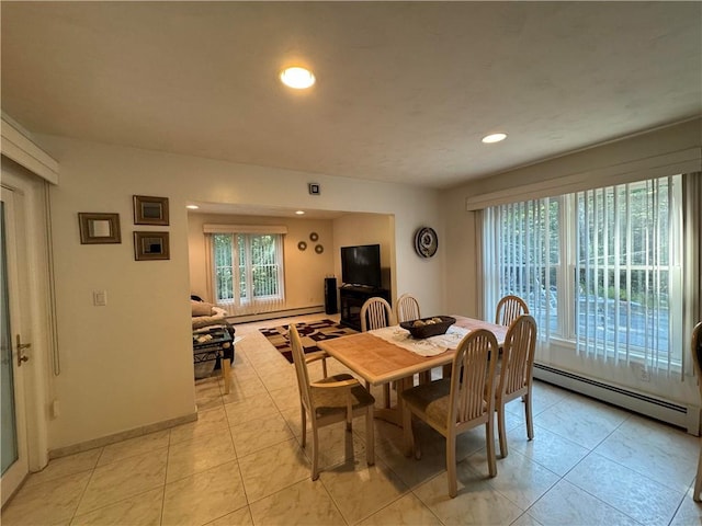 dining room featuring light tile patterned floors and a baseboard radiator