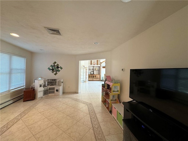 interior space with baseboard heating and light tile patterned flooring