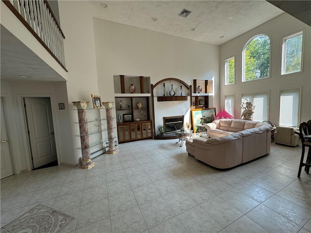 tiled living room with a towering ceiling