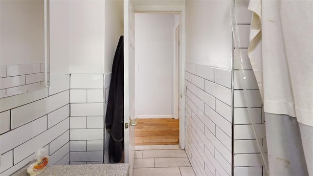 bathroom featuring tile patterned floors and tile walls