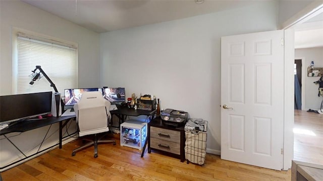 home office with light hardwood / wood-style floors