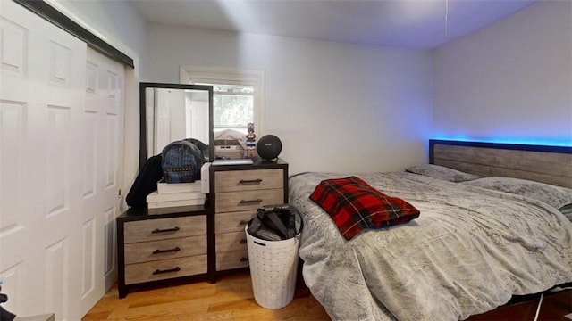 bedroom with a closet and light hardwood / wood-style floors