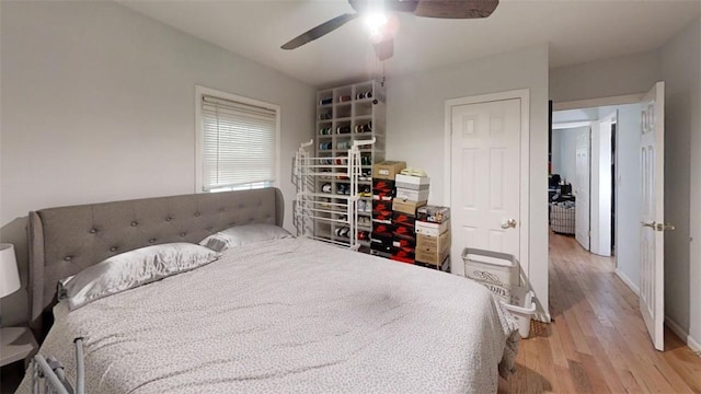 bedroom with ceiling fan and light hardwood / wood-style flooring