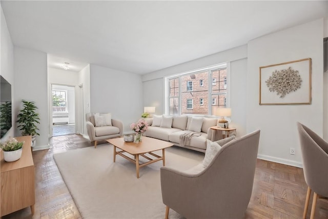 living room featuring plenty of natural light and parquet flooring