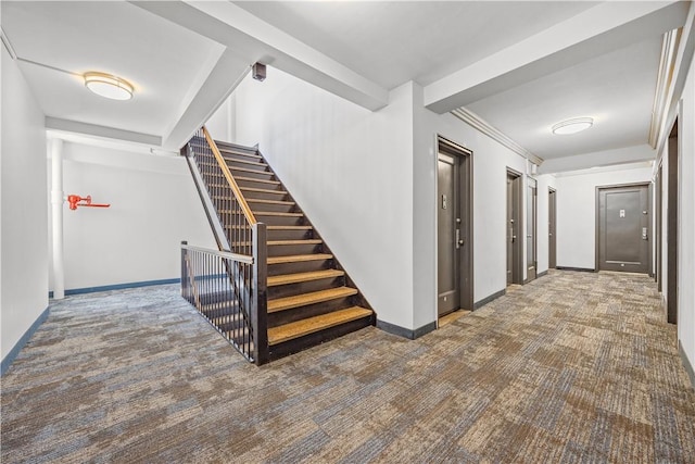 hall with dark colored carpet