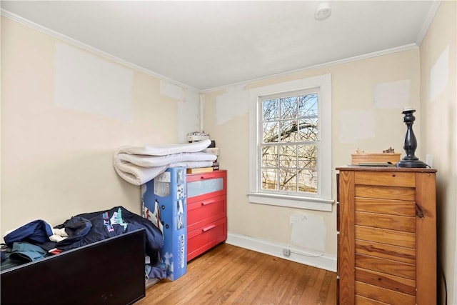 bedroom with hardwood / wood-style floors and ornamental molding