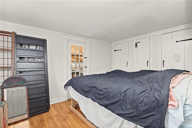 bedroom featuring light hardwood / wood-style flooring and ornamental molding