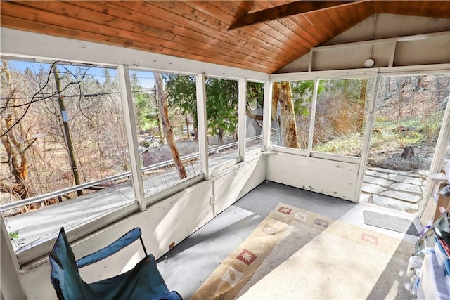 unfurnished sunroom featuring wood ceiling and lofted ceiling