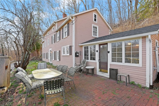 back of property featuring a patio area