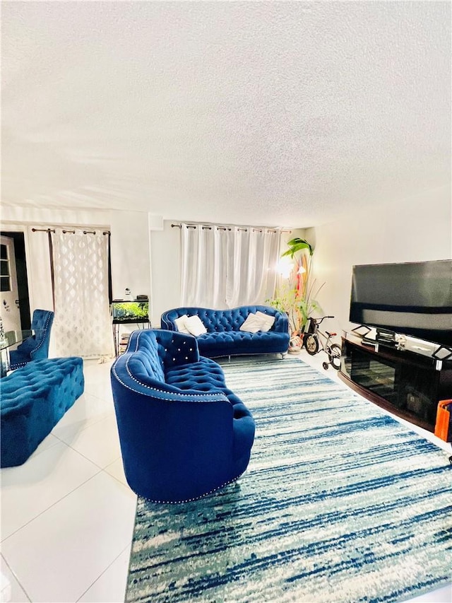 tiled living room featuring a textured ceiling