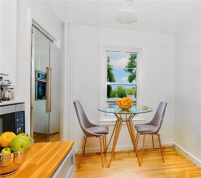 dining space featuring light wood-type flooring