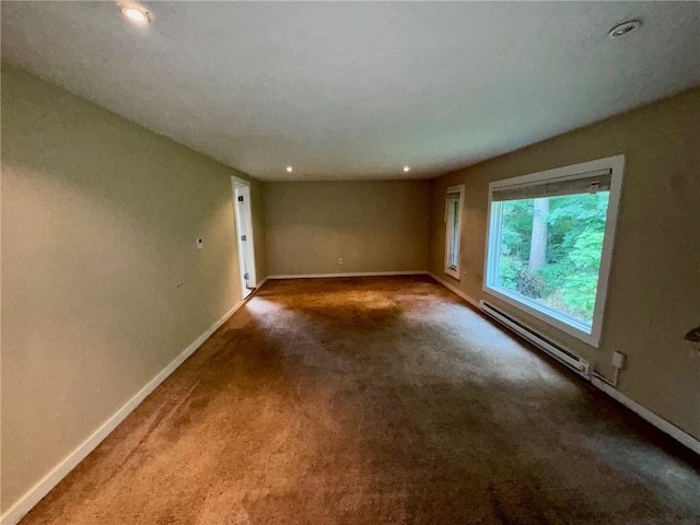 carpeted spare room featuring a baseboard radiator