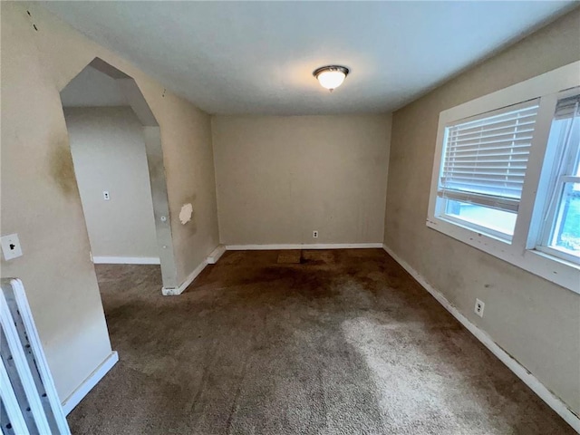 empty room featuring dark colored carpet