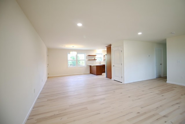 unfurnished living room with light hardwood / wood-style flooring