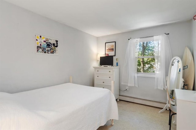 carpeted bedroom featuring baseboard heating