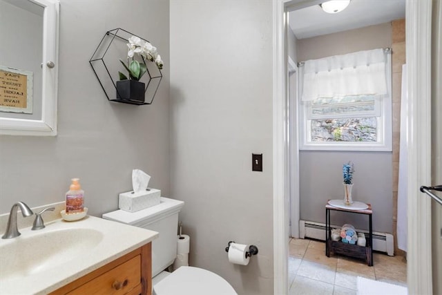 bathroom with tile patterned floors, baseboard heating, vanity, and toilet