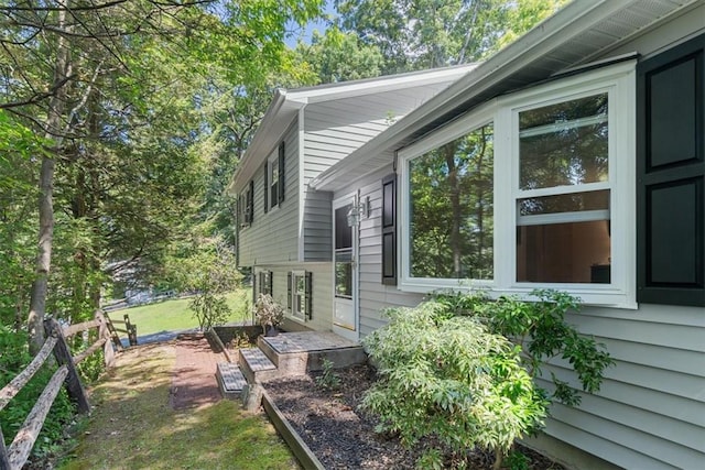 view of property exterior with a lawn