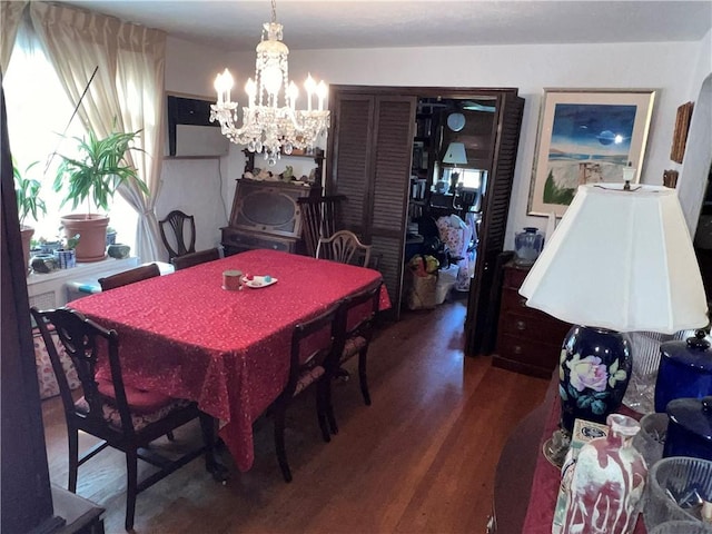 dining room with hardwood / wood-style floors and an inviting chandelier