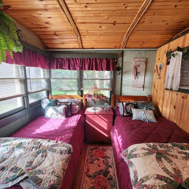 bedroom with vaulted ceiling with beams, wood walls, and wood ceiling