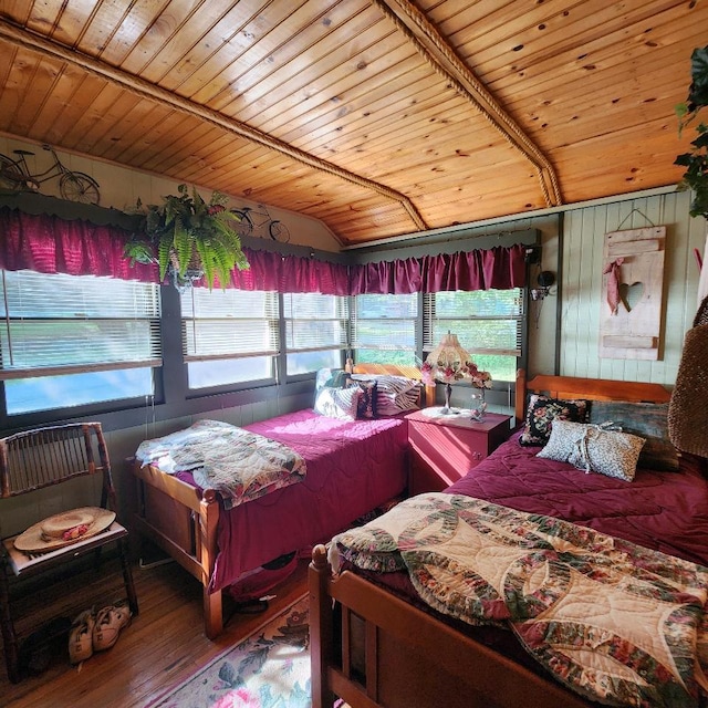 bedroom with hardwood / wood-style floors, vaulted ceiling, wooden ceiling, and multiple windows