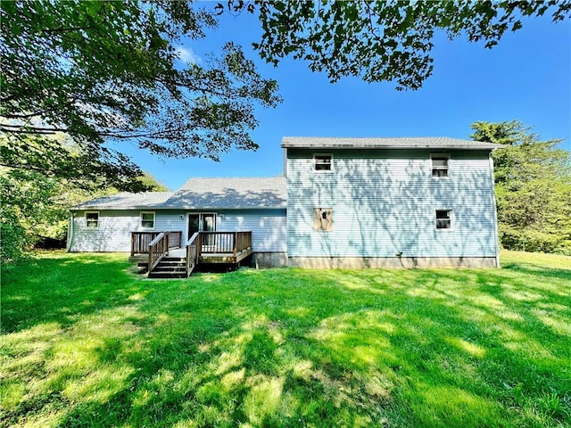 rear view of house featuring a yard and a wooden deck