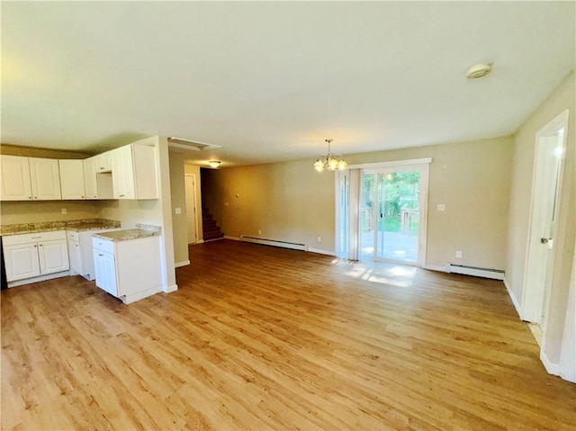 kitchen featuring light hardwood / wood-style floors, white cabinetry, and baseboard heating