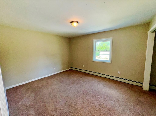 carpeted spare room featuring a baseboard radiator