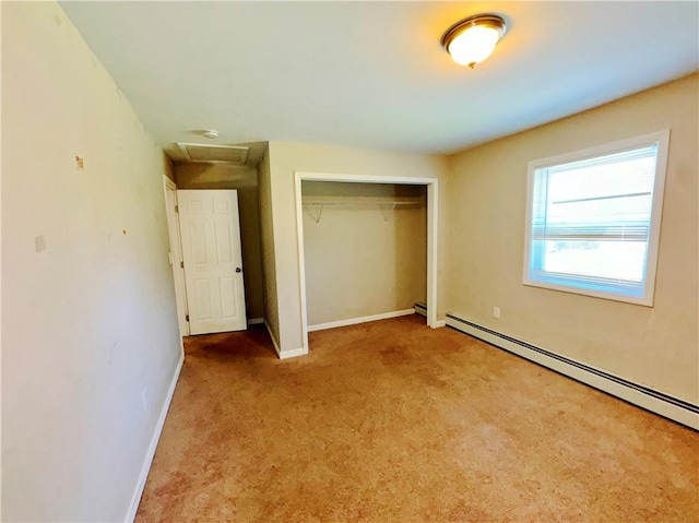 unfurnished bedroom featuring baseboard heating, a closet, and light colored carpet