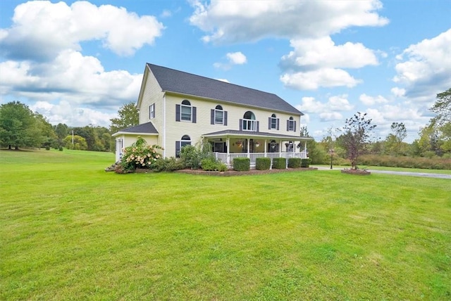 view of front of home featuring covered porch and a front yard