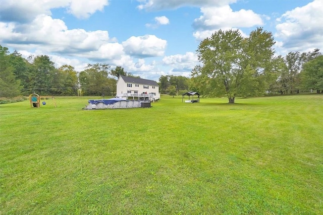 view of yard with a gazebo and a covered pool