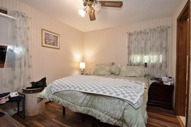 bedroom with ceiling fan and dark wood-type flooring