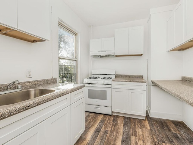 kitchen featuring white gas stove, white cabinets, dark wood-type flooring, and sink