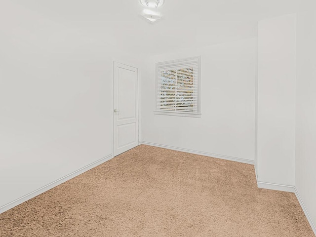 empty room featuring light carpet