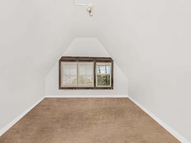 bonus room featuring carpet floors and vaulted ceiling