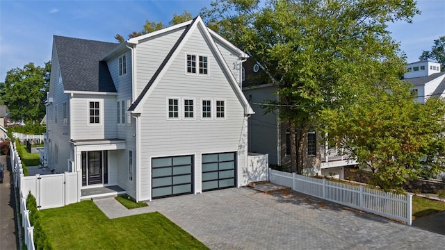 view of front facade featuring a garage and a front lawn