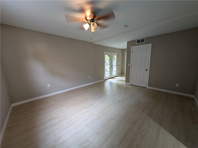 unfurnished room featuring ceiling fan, light wood-type flooring, and french doors