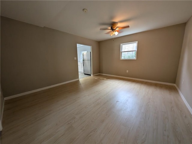 spare room featuring ceiling fan and light hardwood / wood-style floors