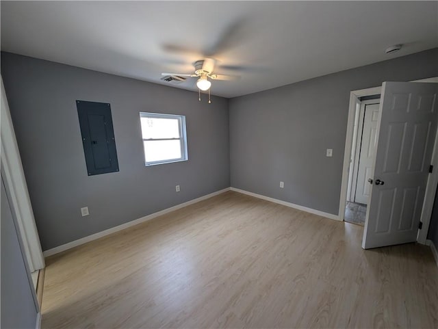 unfurnished bedroom featuring ceiling fan, light wood-type flooring, and electric panel