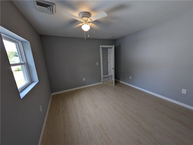 unfurnished room featuring light hardwood / wood-style flooring and ceiling fan