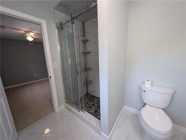 bathroom with wood-type flooring, toilet, and a shower with door