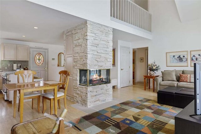 18 Brushy Neck Ln, Westhampton, NY 11977 - living room with light wood-style floors and a stone fireplace