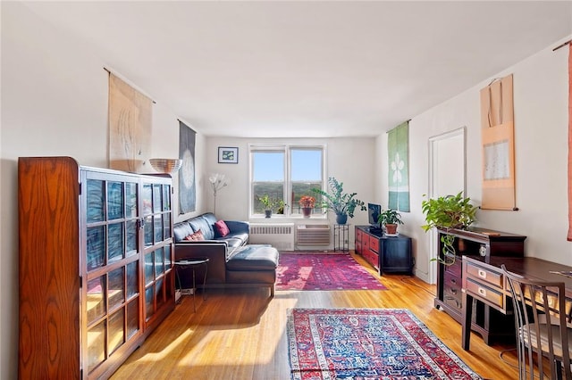 living area featuring radiator heating unit and light wood-type flooring