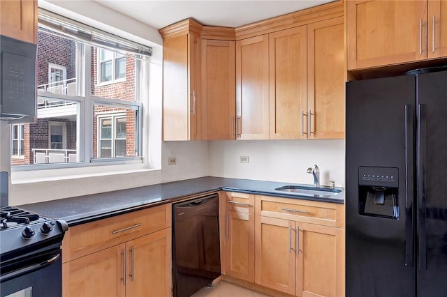 kitchen featuring black appliances, light tile patterned flooring, and sink