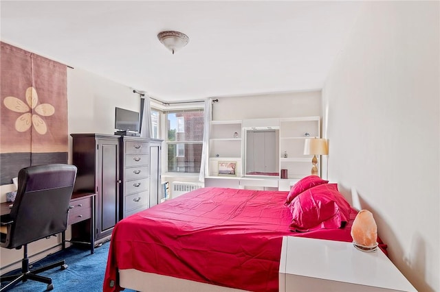 carpeted bedroom featuring radiator heating unit