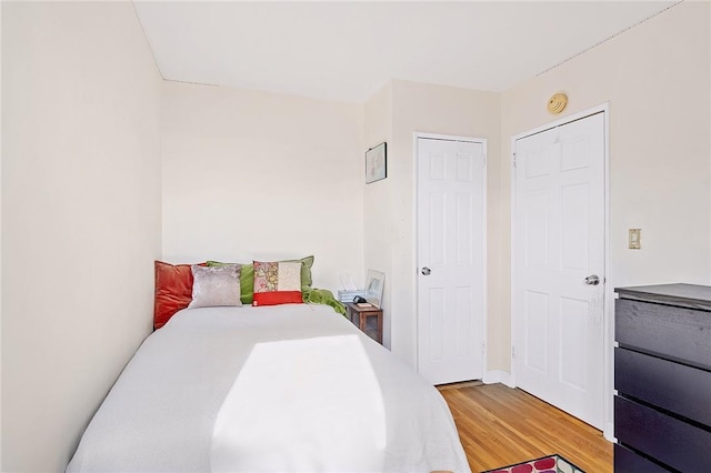 bedroom featuring hardwood / wood-style floors and a closet