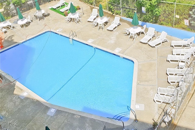 view of swimming pool featuring a patio area