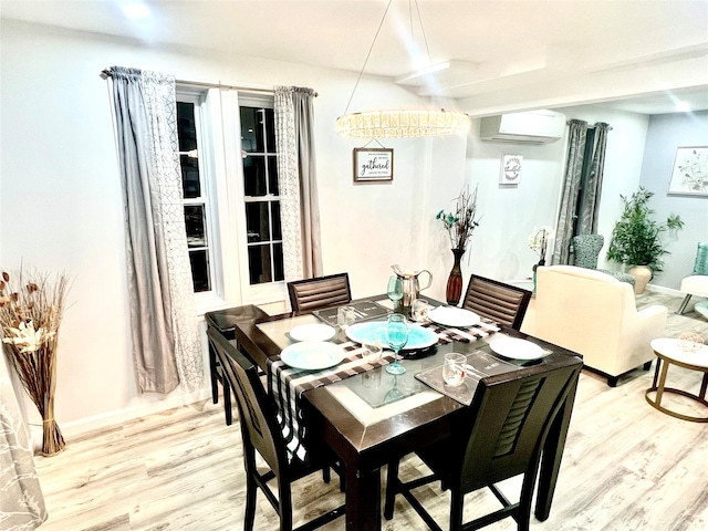 dining space featuring a wall unit AC and light hardwood / wood-style flooring