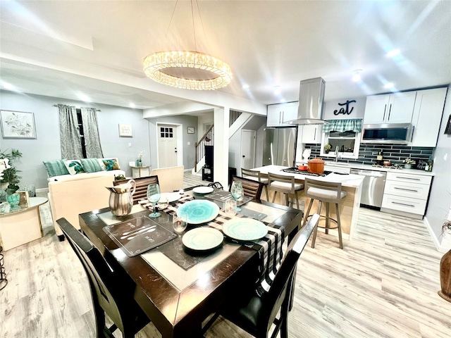 dining space featuring light hardwood / wood-style flooring and sink