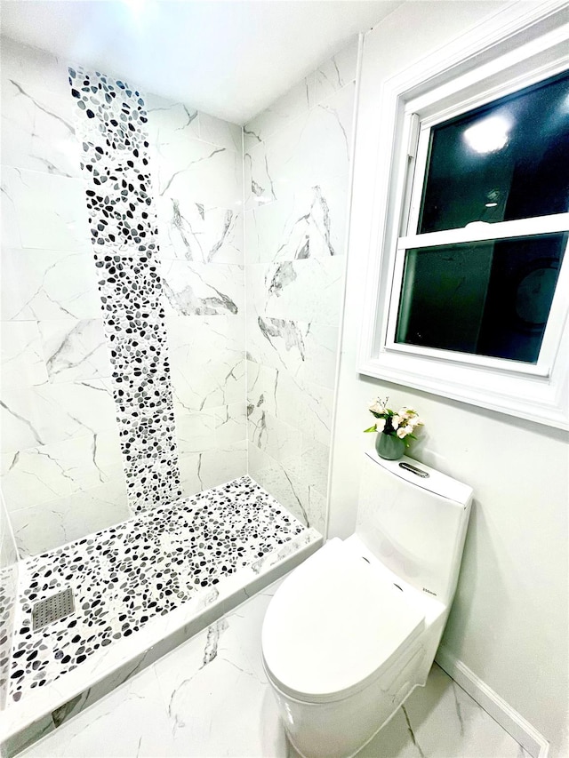 bathroom with toilet and tiled shower